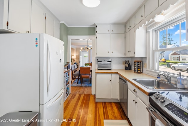 1038 Morgan St, Lansing, MI 48912 - kitchen featuring appliances with stainless steel finishes, a chandelier, plenty of natural light, and a sink