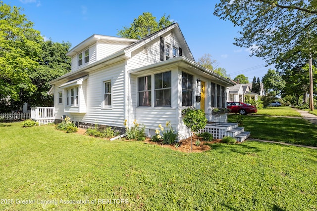 1038 Morgan St, Lansing, MI 48912 - view of property exterior featuring a sunroom and a yard