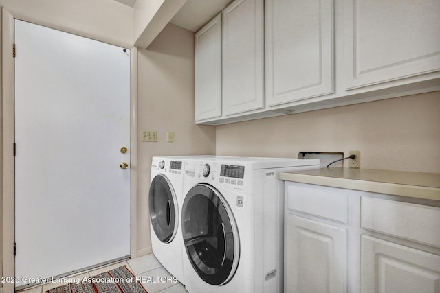 10079 Woodland Acres Dr, Grand Ledge, MI 48837 - clothes washing area featuring cabinet space, washer and clothes dryer, and light tile patterned flooring