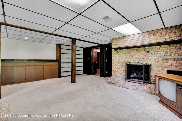 10079 Woodland Acres Dr, Grand Ledge, MI 48837 - finished basement with a paneled ceiling, light colored carpet, and a fireplace
