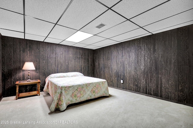 10079 Woodland Acres Dr, Grand Ledge, MI 48837 - bedroom with a paneled ceiling, wooden walls, and carpet floors