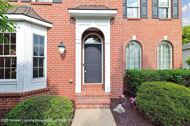 property entrance with brick siding and french doors