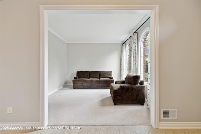 tiled living room with crown molding, baseboards, and carpet flooring