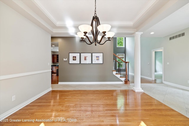 unfurnished dining area featuring a tray ceiling, light tile patterned flooring, a chandelier, stairway, and recessed lighting