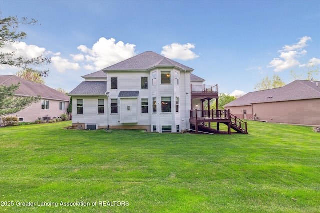 back of house featuring a deck, stairway, a lawn, and a shingled roof