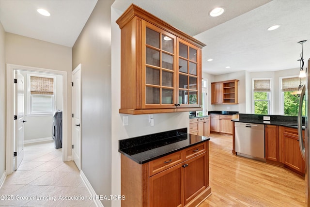 kitchen featuring stainless steel dishwasher, open shelves, dark stone countertops, glass insert cabinets, and recessed lighting