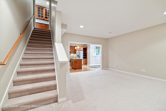 staircase featuring carpet, recessed lighting, and baseboards