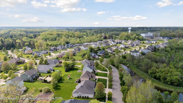 aerial overview of property's location with nearby suburban area and a heavily wooded area