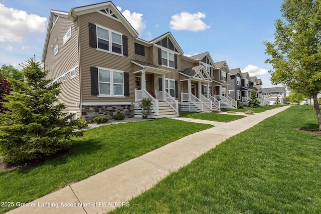 3842 Fossum Ln, Okemos, MI 48864 - multi unit property featuring a residential view, a front yard, covered porch, and stone siding