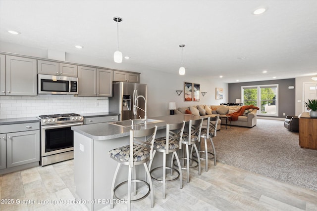 3842 Fossum Ln, Okemos, MI 48864 - kitchen with appliances with stainless steel finishes, gray cabinetry, light wood-type flooring, and recessed lighting