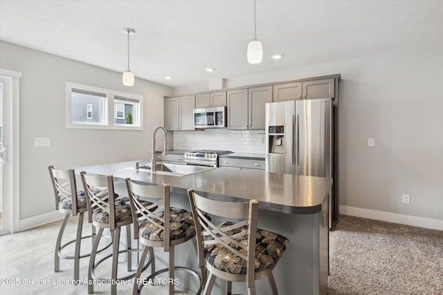 3842 Fossum Ln, Okemos, MI 48864 - kitchen featuring appliances with stainless steel finishes, gray cabinets, a sink, dark countertops, and recessed lighting