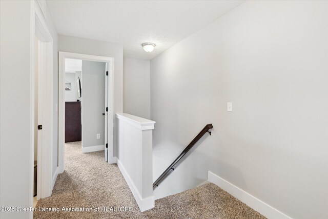 3842 Fossum Ln, Okemos, MI 48864 - corridor with an upstairs landing, light carpet, and baseboards