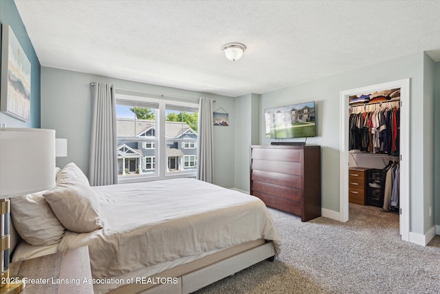 3842 Fossum Ln, Okemos, MI 48864 - bedroom featuring a spacious closet, carpet, a closet, baseboards, and a textured ceiling