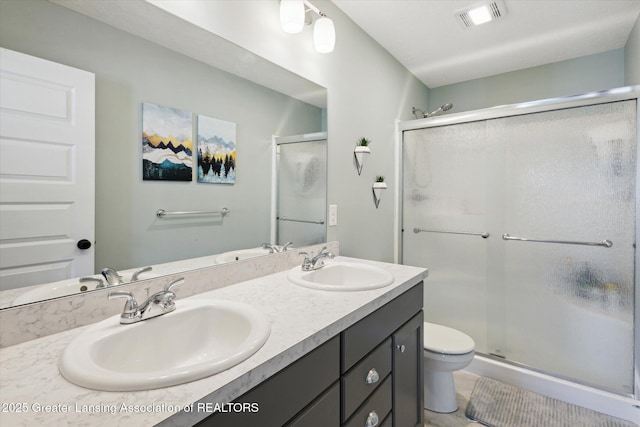 3842 Fossum Ln, Okemos, MI 48864 - full bathroom with a stall shower, toilet, and double vanity