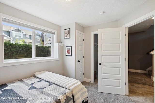 3842 Fossum Ln, Okemos, MI 48864 - bedroom with baseboards and a textured ceiling