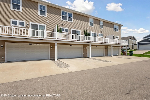 3842 Fossum Ln, Okemos, MI 48864 - back of house with a garage and driveway
