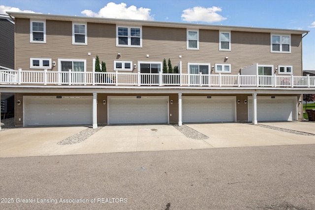 3842 Fossum Ln, Okemos, MI 48864 - back of property featuring a garage and driveway
