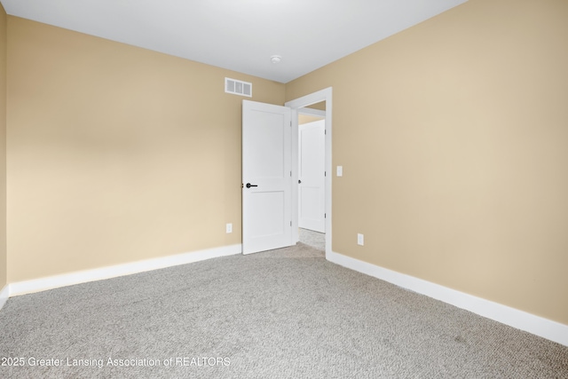 1229 W Saginaw St, Lansing, MI 48915 - carpeted empty room featuring baseboards