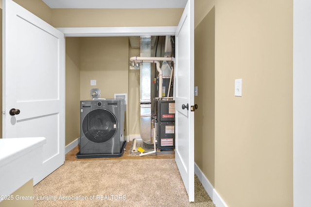 1229 W Saginaw St, Lansing, MI 48915 - laundry area featuring washer / clothes dryer, carpet flooring, baseboards, and heating unit
