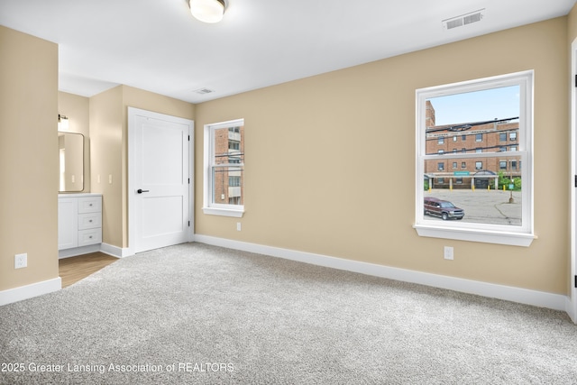 1229 W Saginaw St, Lansing, MI 48915 - unfurnished bedroom with carpet floors and baseboards