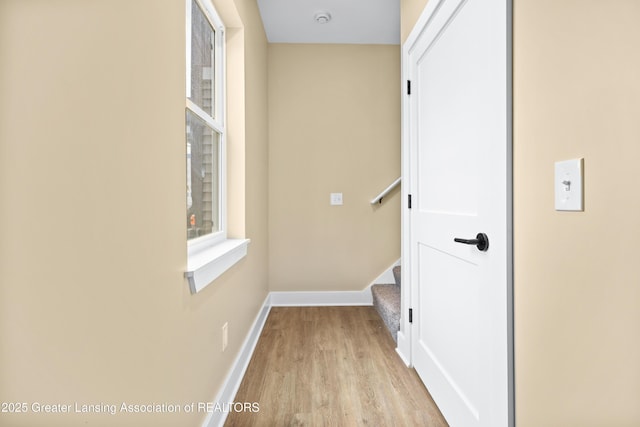 1229 W Saginaw St, Lansing, MI 48915 - hall featuring light wood-type flooring, baseboards, and stairway