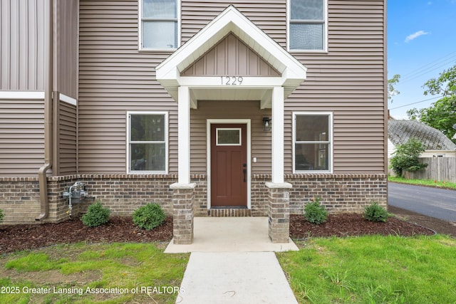1229 W Saginaw St, Lansing, MI 48915 - property entrance with brick siding and board and batten siding