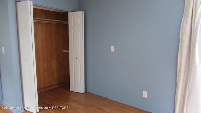 745 Roosevelt St, Mason, MI 48854 - unfurnished bedroom with wood finished floors, a closet, and baseboards
