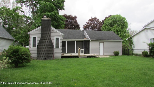 745 Roosevelt St, Mason, MI 48854 - rear view of property with a chimney, roof with shingles, and a sunroom