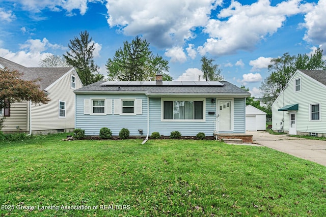 2018 Cooper Ave, Lansing, MI 48910 - view of front of property with solar panels, a front lawn, an outdoor structure, a chimney, and roof with shingles