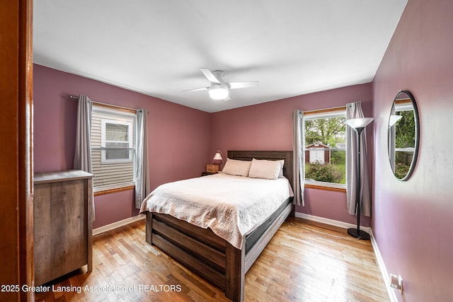 2018 Cooper Ave, Lansing, MI 48910 - bedroom with light wood-style flooring, baseboards, and a ceiling fan