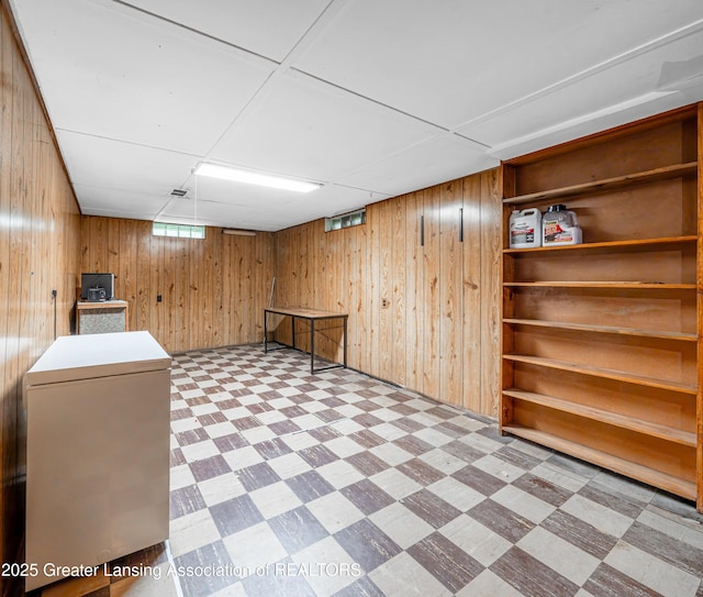 2018 Cooper Ave, Lansing, MI 48910 - below grade area featuring light floors, wooden walls, and a paneled ceiling