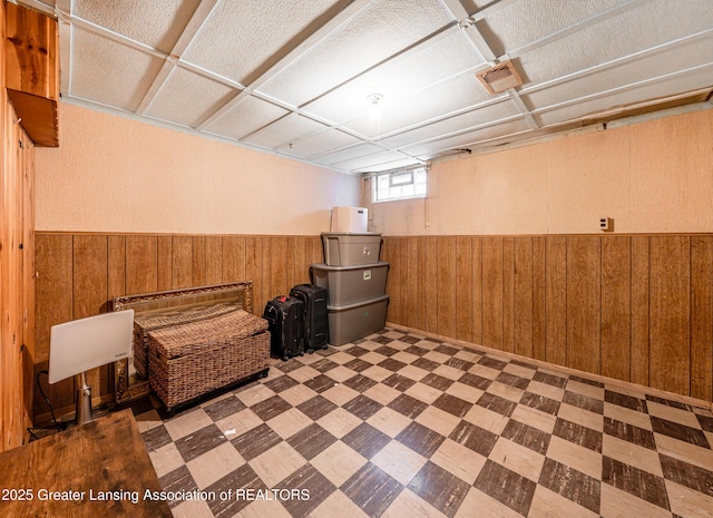 2018 Cooper Ave, Lansing, MI 48910 - basement featuring tile patterned floors, wooden walls, and a wainscoted wall
