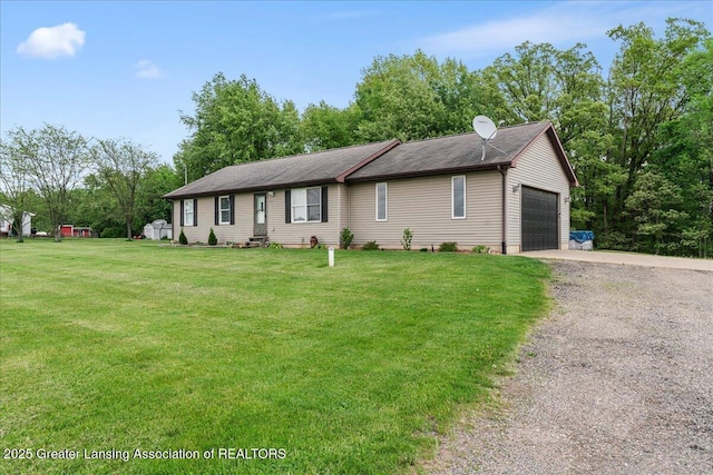 5669 Elm Rd, Olivet, MI 49076 - single story home with driveway, a front yard, a garage, and view of scattered trees