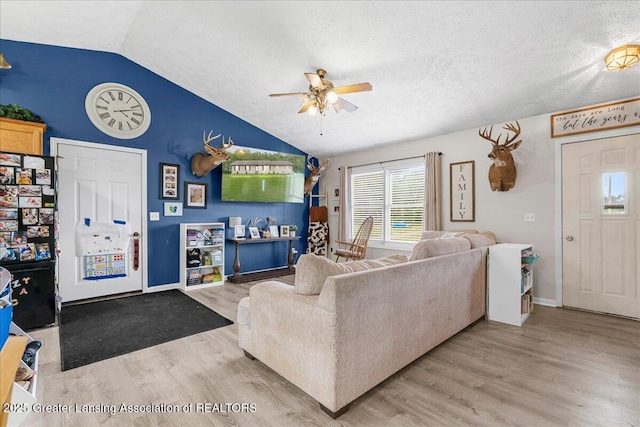 5669 Elm Rd, Olivet, MI 49076 - living area with a ceiling fan, lofted ceiling, wood finished floors, a textured ceiling, and baseboards