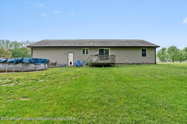 5669 Elm Rd, Olivet, MI 49076 - rear view of house featuring a deck, a covered pool, and a lawn