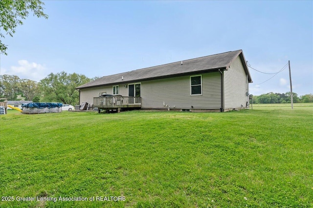 5669 Elm Rd, Olivet, MI 49076 - rear view of property featuring a wooden deck and a lawn