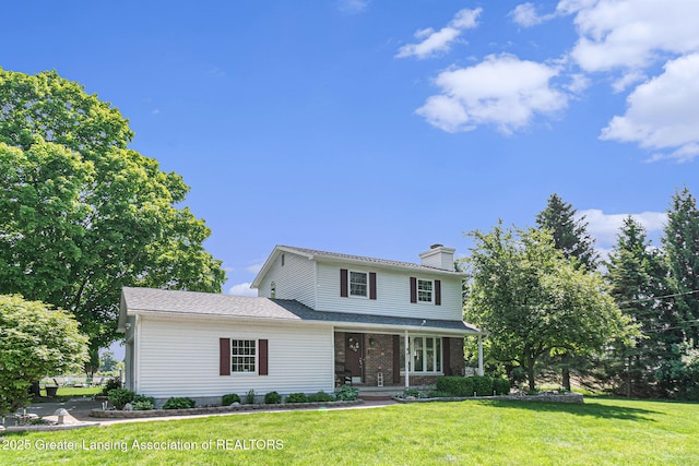 985 Ives Rd, Mason, MI 48854 - traditional home with covered porch, a chimney, and a front yard