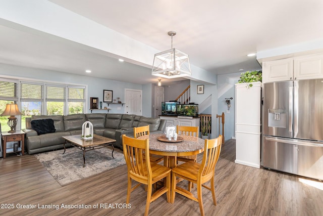 985 Ives Rd, Mason, MI 48854 - dining space featuring light wood finished floors, stairs, recessed lighting, and a chandelier
