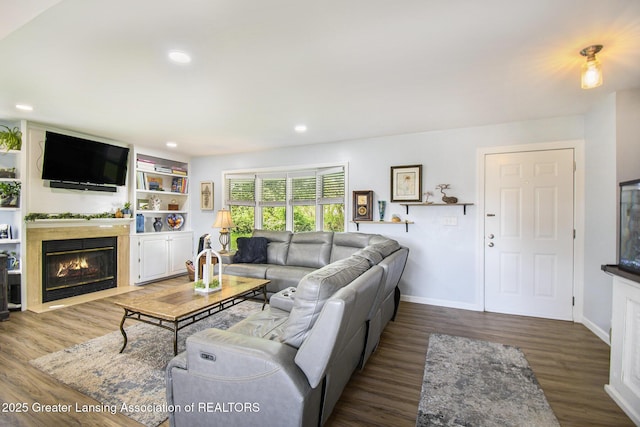 985 Ives Rd, Mason, MI 48854 - living area featuring a fireplace with flush hearth, wood finished floors, recessed lighting, and baseboards