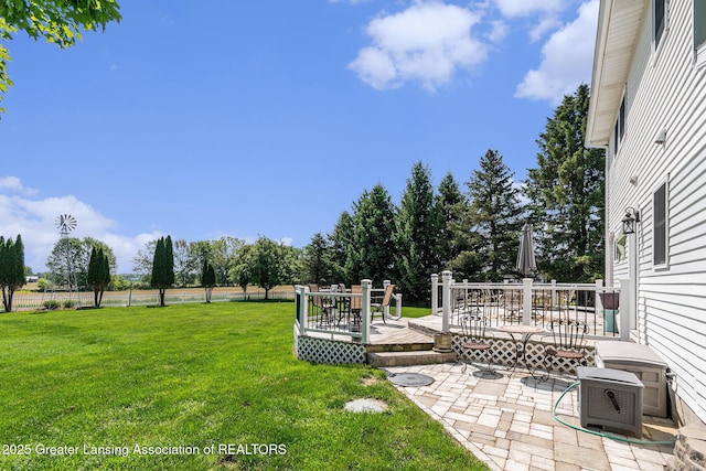 985 Ives Rd, Mason, MI 48854 - view of grassy yard featuring a wooden deck and a patio