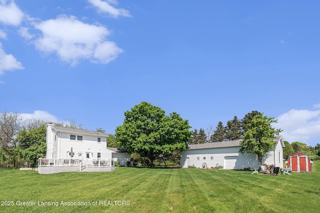 985 Ives Rd, Mason, MI 48854 - view of grassy yard featuring a shed, an outdoor structure, and a wooden deck
