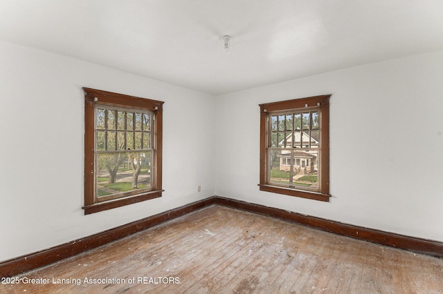 1215 Chittock Ave, Jackson, MI 49203 - spare room featuring hardwood / wood-style floors and baseboards
