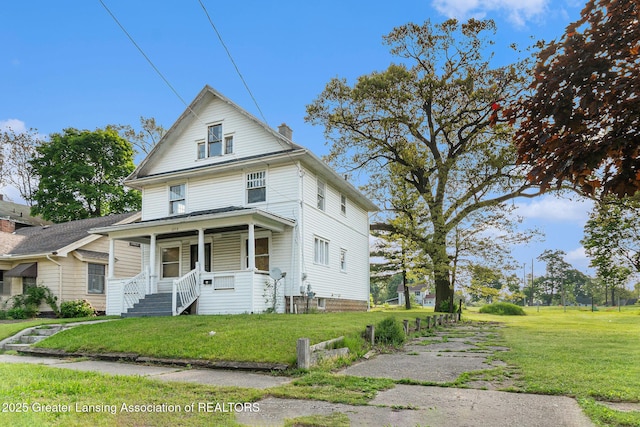 1215 Chittock Ave, Jackson, MI 49203 - american foursquare style home featuring a chimney, a front lawn, and a porch