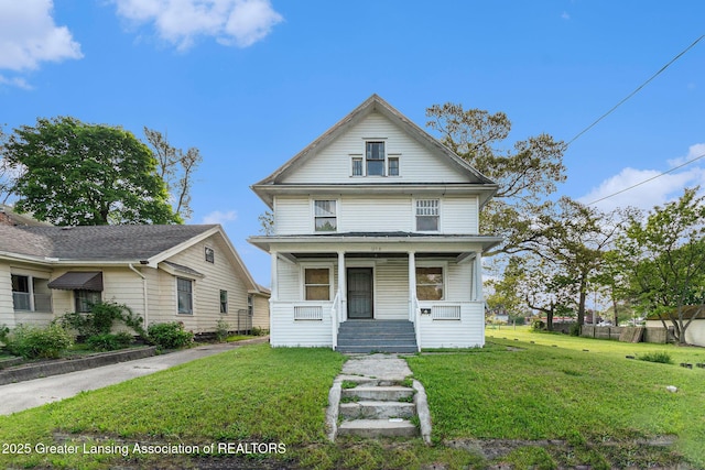1215 Chittock Ave, Jackson, MI 49203 - american foursquare style home with a porch and a front lawn