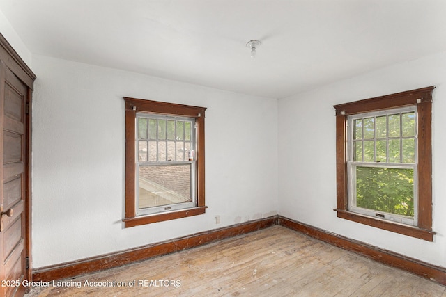 1215 Chittock Ave, Jackson, MI 49203 - unfurnished room with plenty of natural light, baseboards, and wood finished floors