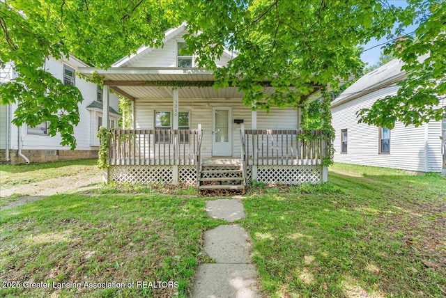 1200 W Lenawee St, Lansing, MI 48915 - bungalow with covered porch and a front lawn
