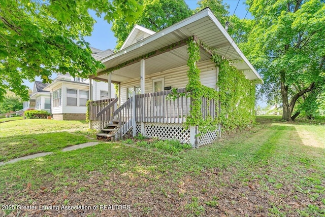 1200 W Lenawee St, Lansing, MI 48915 - view of front of home featuring covered porch and a front lawn