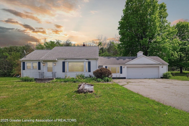 2468 Lansing Rd, Charlotte, MI 48813 - view of front of home with driveway, an attached garage, a front lawn, a chimney, and a shingled roof