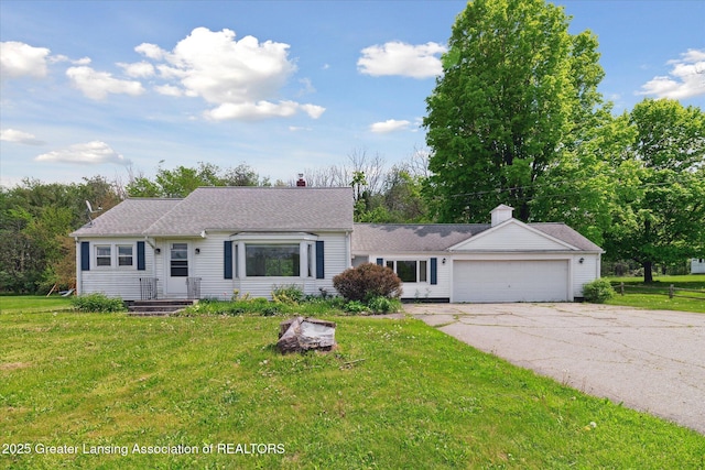 2468 Lansing Rd, Charlotte, MI 48813 - view of front of house featuring an attached garage, a front lawn, and driveway