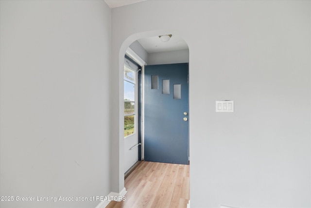 2468 Lansing Rd, Charlotte, MI 48813 - corridor with arched walkways and light wood finished floors